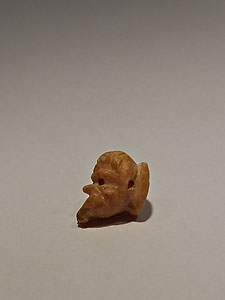 Small button in the form of mask of theater - Coral