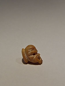 Small button in the form of mask of theater - Coral