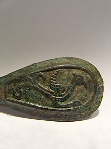 Fastening decorated in relief with a fantastic bird - Bronze